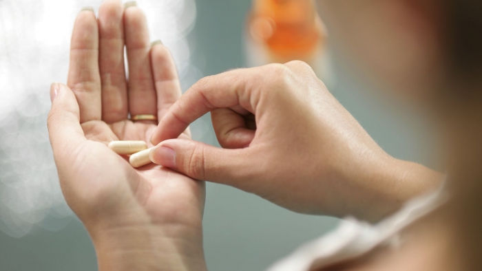 A woman in taking a tablet